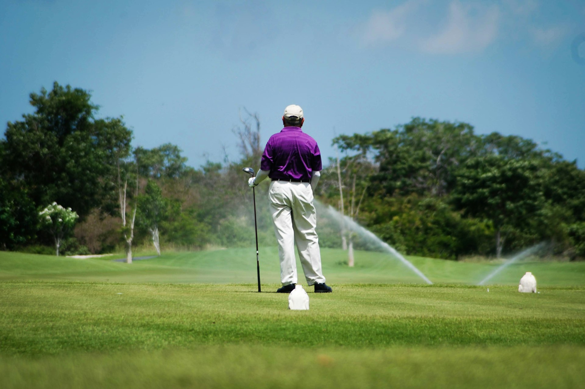 Golf course sprinklers irrigating a fairway